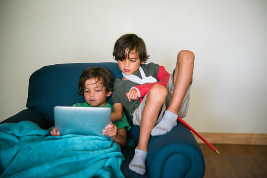 brothers looking at a tablet device