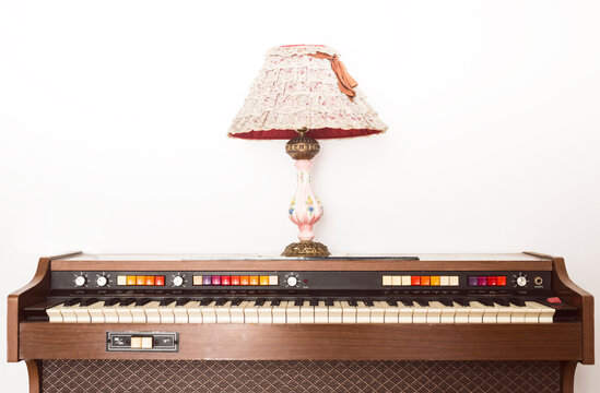 Old piano with vintage table lamp