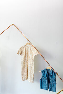 vintage clothing pieces hung on rack in diy fashion studio workshop space