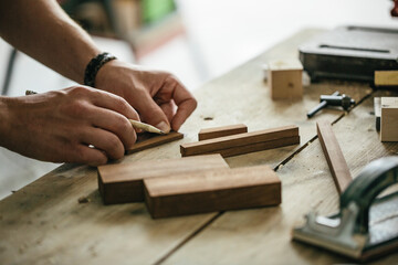 Young carpenter working at his workshop