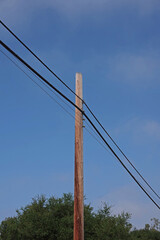 Low angle close  view of the upper part of an Electricity Distribution Pylon with its cables and power lines