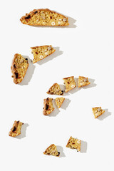 Several pieces Italian biscotti cookies on white background. Fresh broken cookies