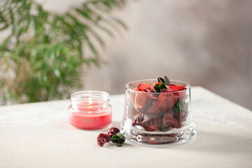 Dried flowers in a glass and candle. Flower flavor, home aromatherapy