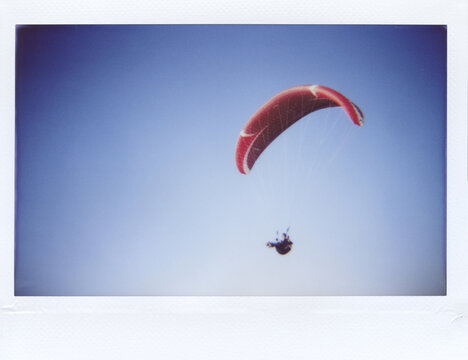 Man paragliding on wing in the sky.