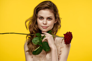 Nice girl with red rose on yellow background cropped view of emotion model