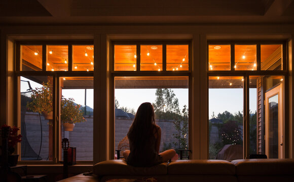 Teen Girl Looking At Patio Lights