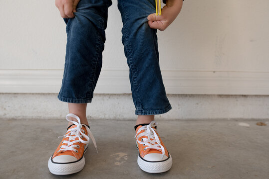 A Boy With Short Pants And Brand New Orange Shoes