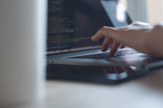 Software developer program coding on laptop computer for digital software technology development