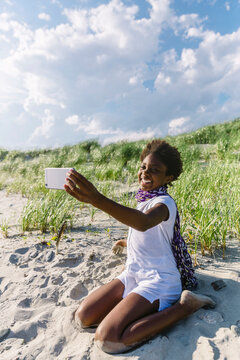 Beautiful Young African American Girl taking Selfie with Cellular Phone