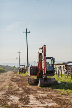 Many bulldozers left on rural track in italian farmhouse in Tuscany