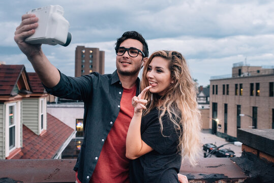Young friends taking pictures in the city