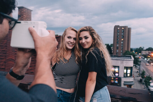 Young friends taking pictures in the city