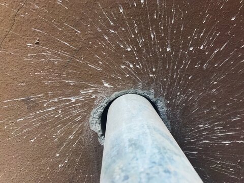 Detail of paint splatter on wall, drill in foreground