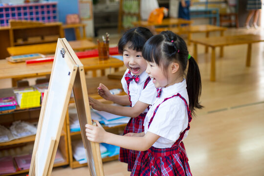 Two litte asian girl in the kindergarten