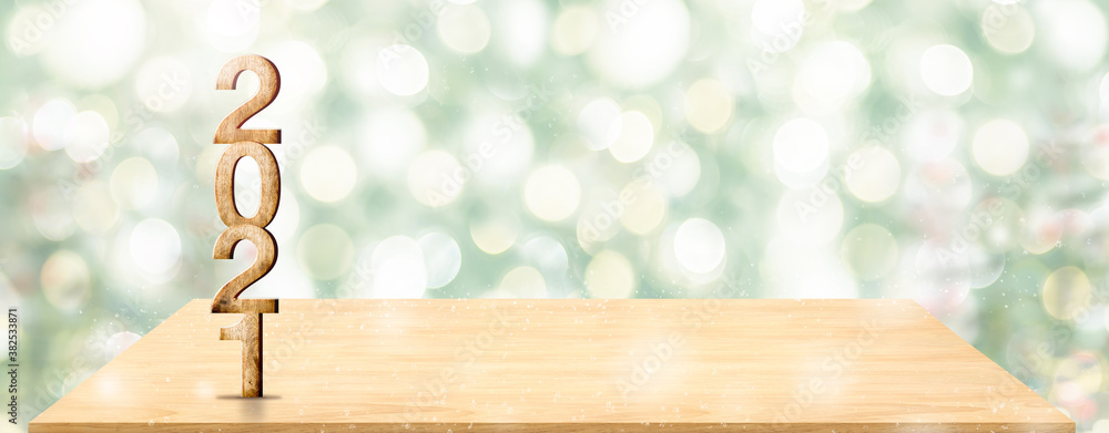 Poster new year 2021 white wood number (3d rendering) on wooden table at blur abstract green christmas tree