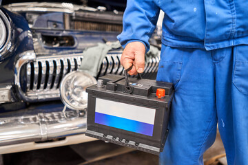 Engine engineer is replacing car battery because car battery is depleted. concept car maintenance....