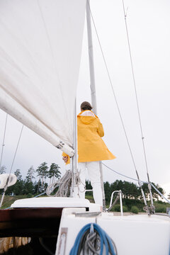 Woman in raincoat on boat