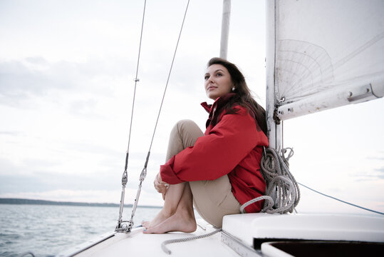 Woman in coat sitting on boat