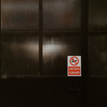 No smoking sign on iron and glass industrial door