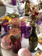 still life of flowers and drinks, vertical. Soft focus