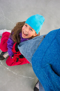 Spontaneous Winter Photo Of Tricky Girl Wrapped Around Dad's Leg