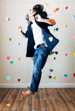 Young boy happily dancing alone