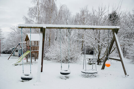 Playground in winter covered in snow
