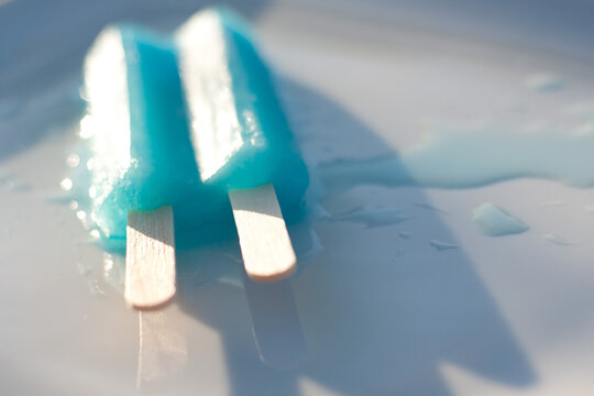 blue popsicle melting on a plate