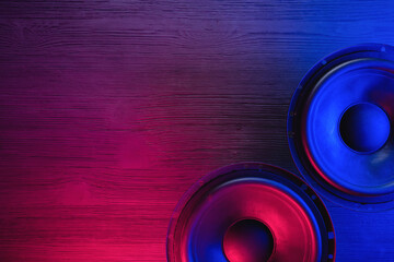 A car audio loudspeaker on the table in the neon lights.