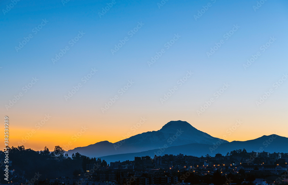 Wall mural Quito city at sunrise with Cayambe volcano silhouette, Ecuador. - Wall murals