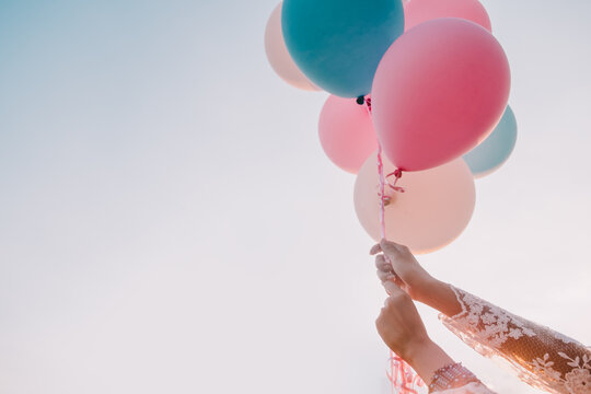 Woman Holding Balloons