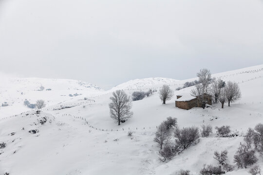 Stone house on snowy landscape