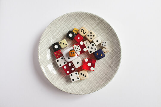 A small dish filled with colourful vintage dice