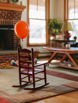 Someone attached an Orange Balloon to my Rocking Chair