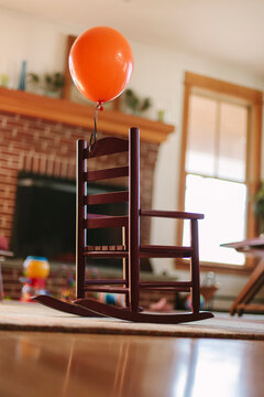 Someone attached an Orange Balloon to my Rocking Chair