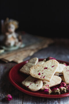 Heart shaped cookies and dried rose buds