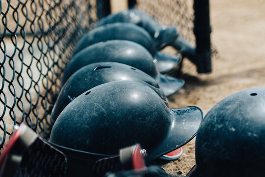 Baseball helmets by a wire fence