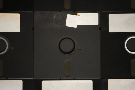 A bunch of old floppy disks all arranged neatly.
