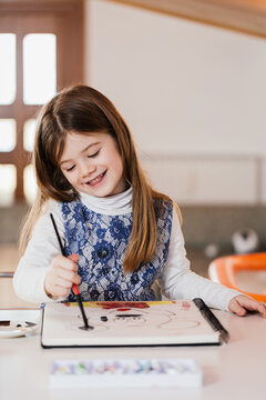 Young girl drawing at home