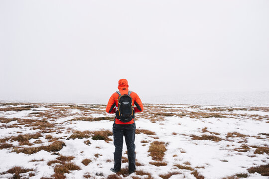 Male standing on the snow covered moorland of Bleaklow.