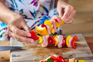 woman preparing skewers