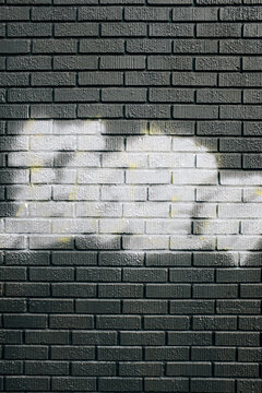 Fototapeta Metallic silver spray paint covering graffiti tags on brick wall