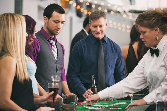 Casino: Group Of People Playing Blackjack At Table