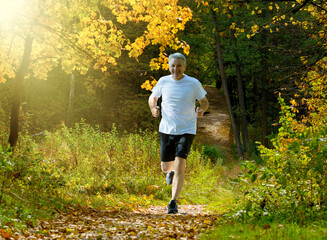 Man running in autumn park