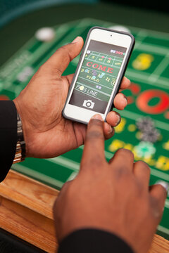 Casino: Man Taking Cel Phone Image Of Craps Table