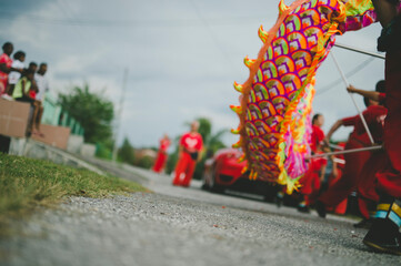 Dragon dance performance being watched by multi-ethnic group