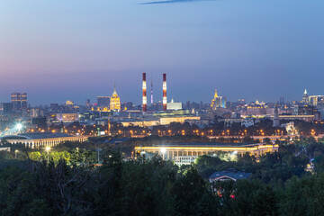 Fototapeta na wymiar view of central Moscow from Sparrow Hills or Vorobyovy Gory observation (viewing) platform at sunset-- is on a steep bank 85 m above the Moskva river, or 200 m above sea level. Russia
