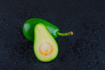 Avocados on a dark grey background. high angle view.
