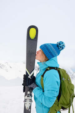 Young woman kissing her skis