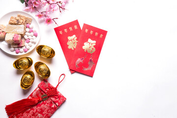 Chinese new year festival decorations, ang pow,chinese sweetmeat ,red packet and gold ingots on...